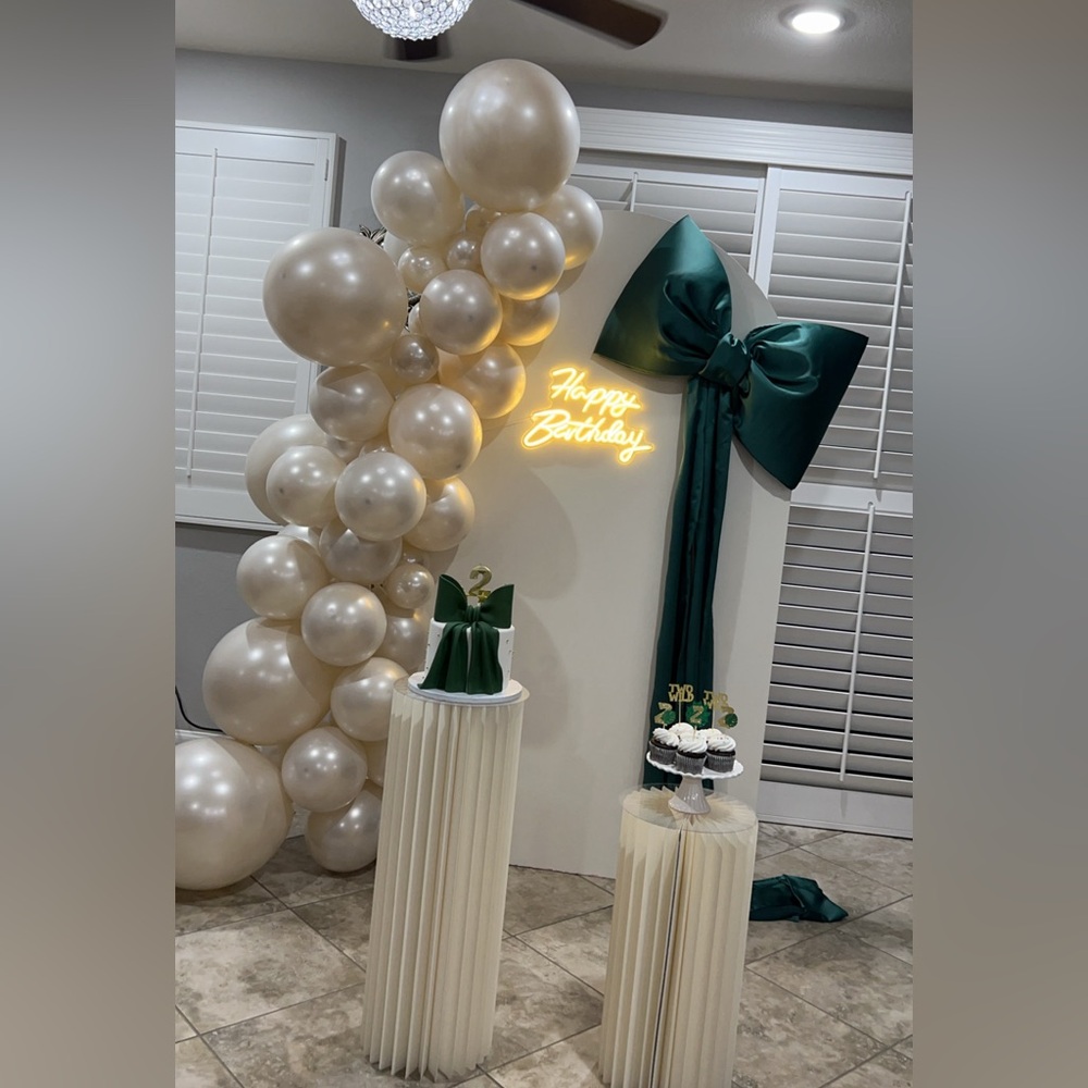 A large, emerald green satin bow lies for any decoration